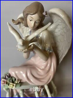 Mark O'Well large angel withopalescent wings leaning on trellis holding dove