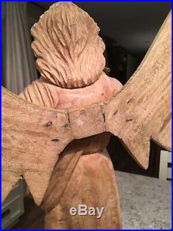 Very large, 29 tall, hand carved wood Angel, with wings and a horn on a pedestal
